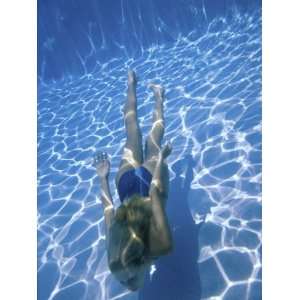  Young Woman Swimming Underwater in a Swimming Pool Premium 