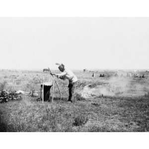  1911 photo High Bear, Brul Sioux man cooking by throwing 