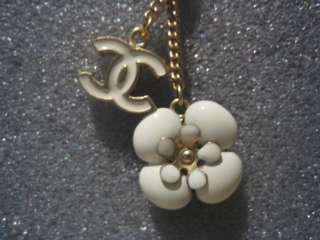 Authentic Chanel white CC Logo and Camellia Dangling Charm Earrings 