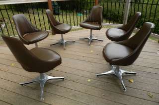   modern set of 6 vinyl chairs on heavy metal swivel bases  