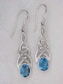   silver celtic braided knot dangle earrings with synthetic blue topaz